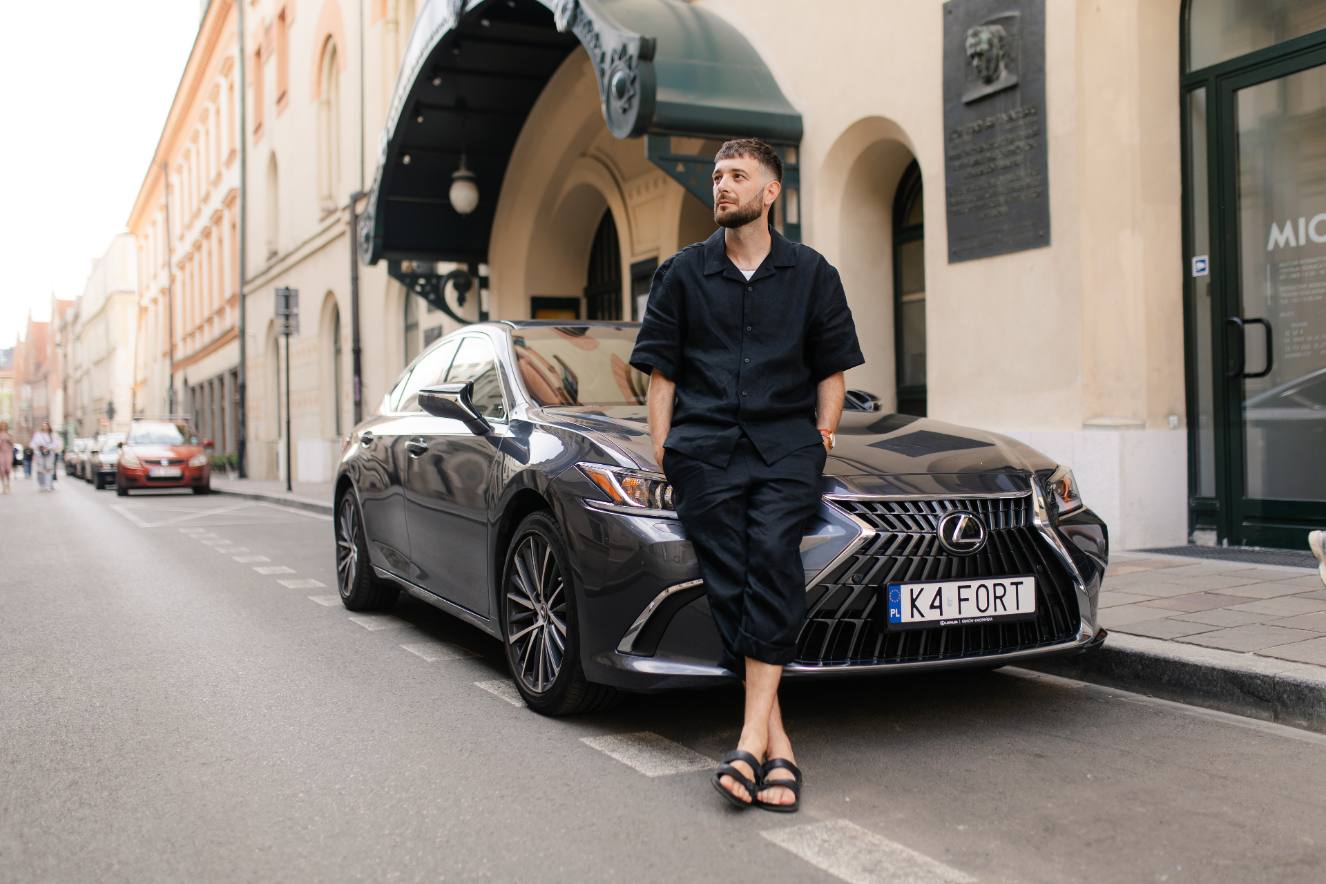 Black Lexus ES limousine parked on a historic Kraków street