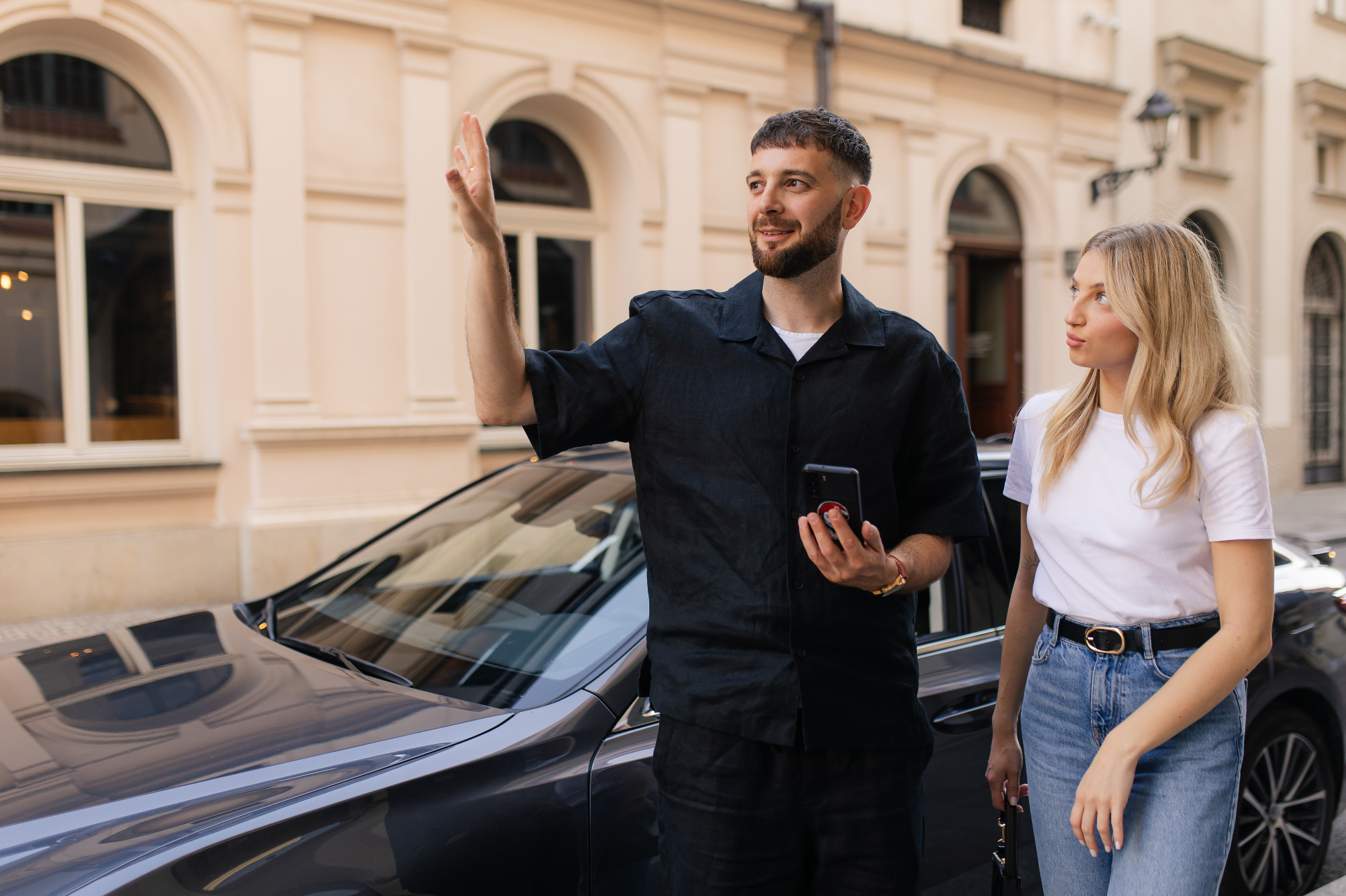 Chauffeur welcoming guests beside the Lexus ES limousine
