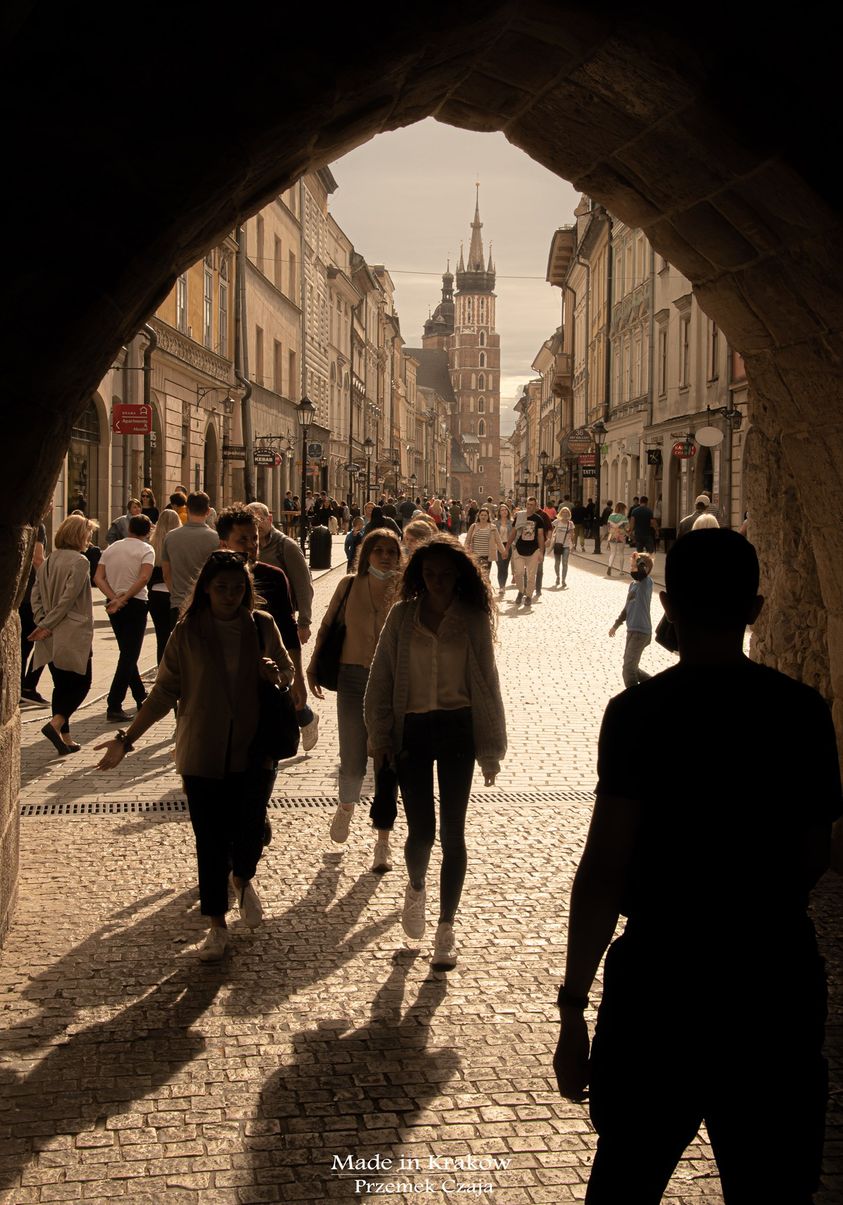 St. Florian's Gate framing St. Mary's Basilica on a busy Kraków street