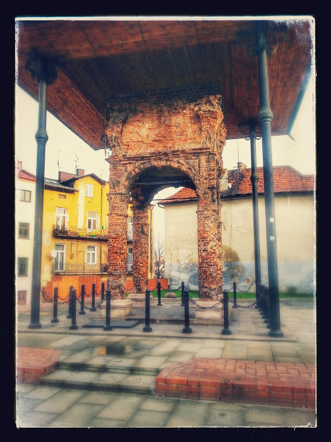 Historic brick monument in a Kraków courtyard visited on a heritage journey